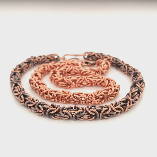 Movie of two Byzantine chain maille bracelets: natural copper with cast lobster clasp; patinated copper with double-heart clasp.