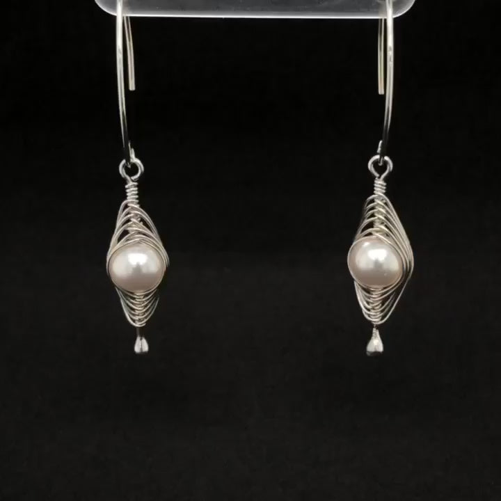 Video, pearl and Argentium silver herringbone earrings, medium, black background.