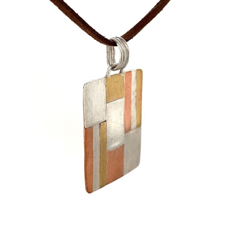 Tri-metal Ribbon Pendant (Argentium Silver, Copper, Brass) - Hanging on cord, 3/4 view - Barb Murrin Jewelry